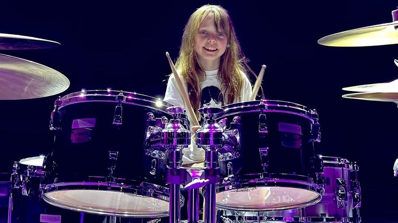 Summer playing the drums