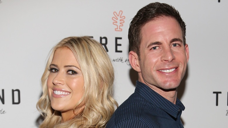 Cristina Hall and Tarek El Moussa sitting back to back