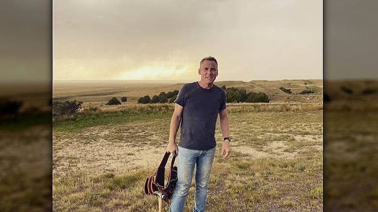 Clint Harp posing with a saddle