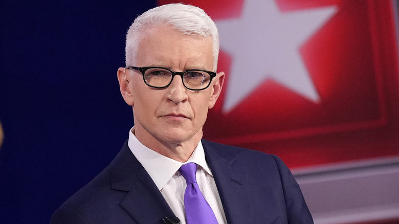 Anderson Cooper at a CNN event with Kamala Harris and an American Flag background