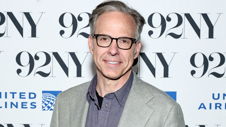 Jake Tapper wearing a suit at a press event in 2025