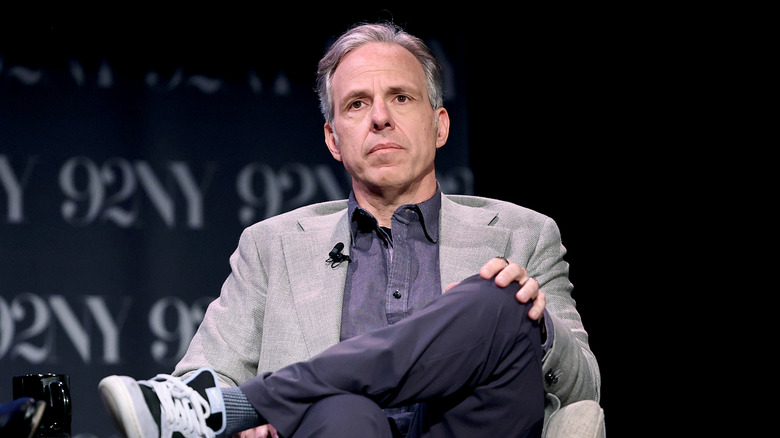 Jake Tapper sitting with crossed legs