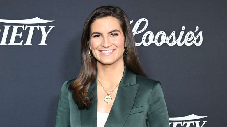 Kaitlan Collins in a green jacket