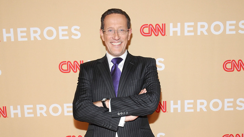 Richard Quest folds his arms at a CNN event