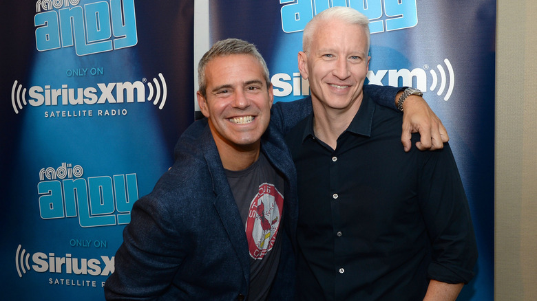 Andy Cohen (L) and Anderson Cooper posing for photo at "Andy Cohen Live!" 