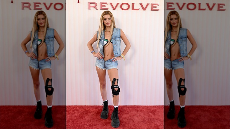 Dixie D'Amelio posing in a denim look at a Revolve event during Coachella 2026
