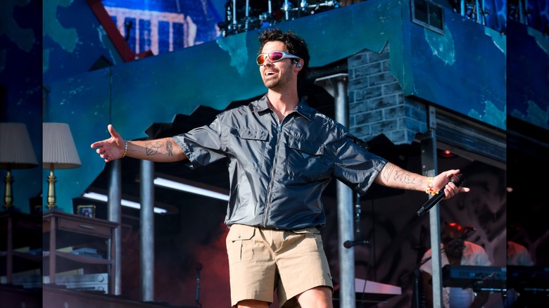 Joe Jonas performing onstage at Coachella 2026 while smiling