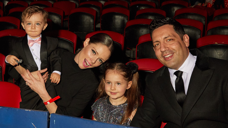 Coco Rocha and James Conran posing with kids