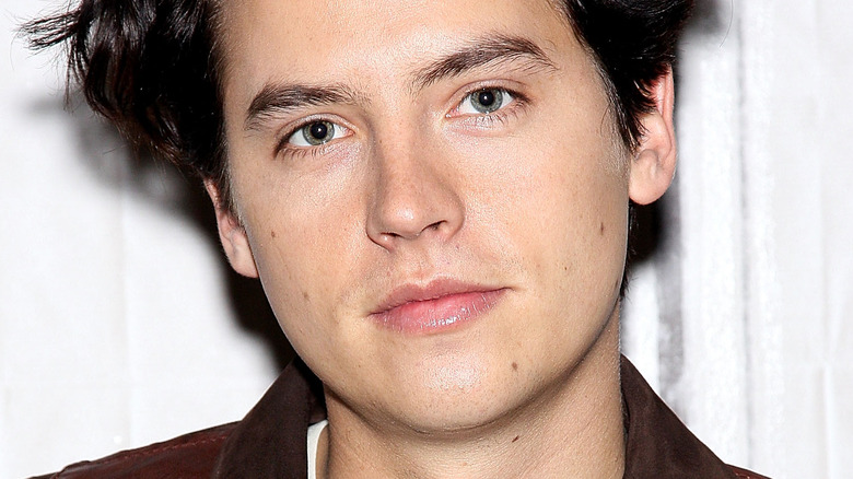 Cole Sprouse smirking 