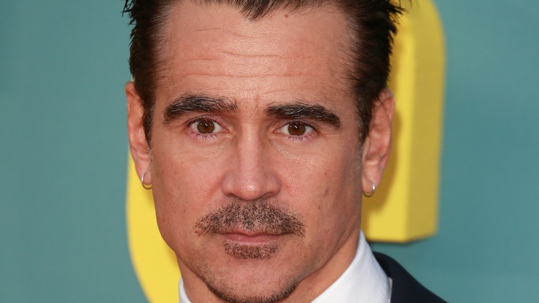 Colin Farrell closed mouth smile with earrings