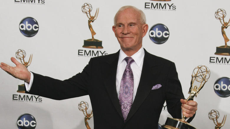 Tom Smothers holding an Emmy