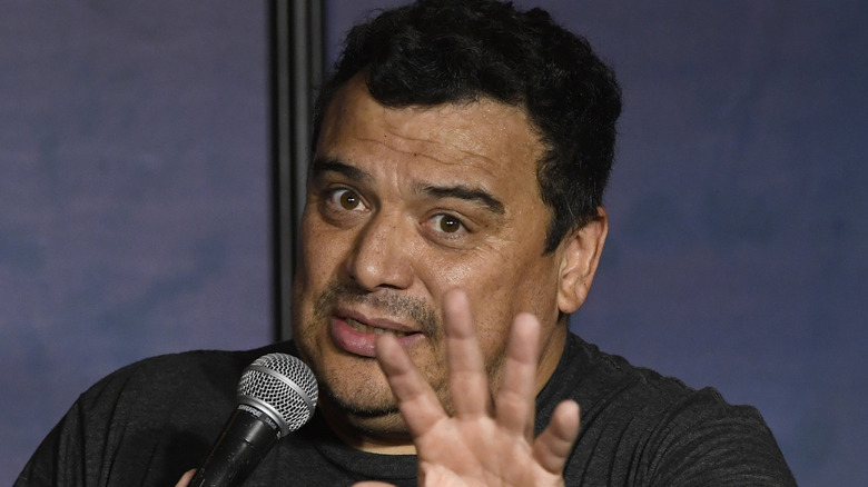 Comic Carlos Mencia holding a microphone