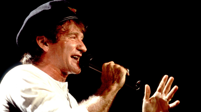 Robin Williams performs with a cap on