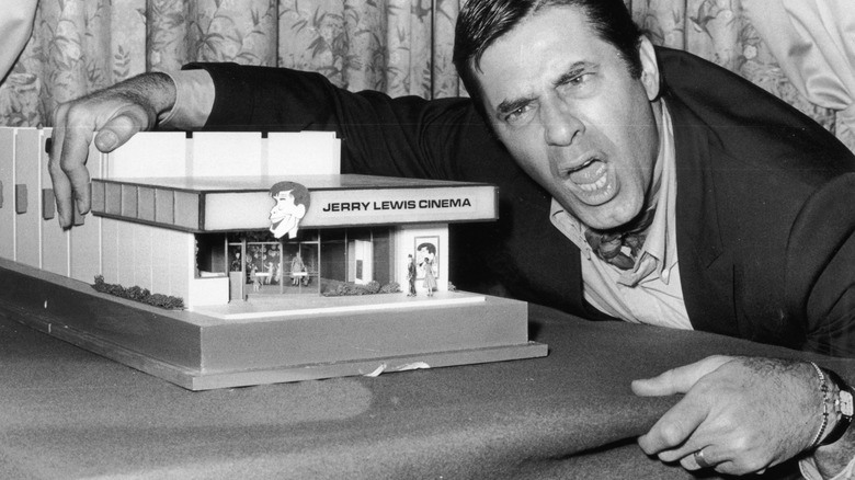 Jerry Lewis glaring next to a model movie theatre