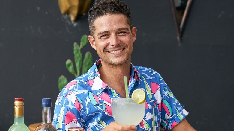 Wells Adams holding a drink