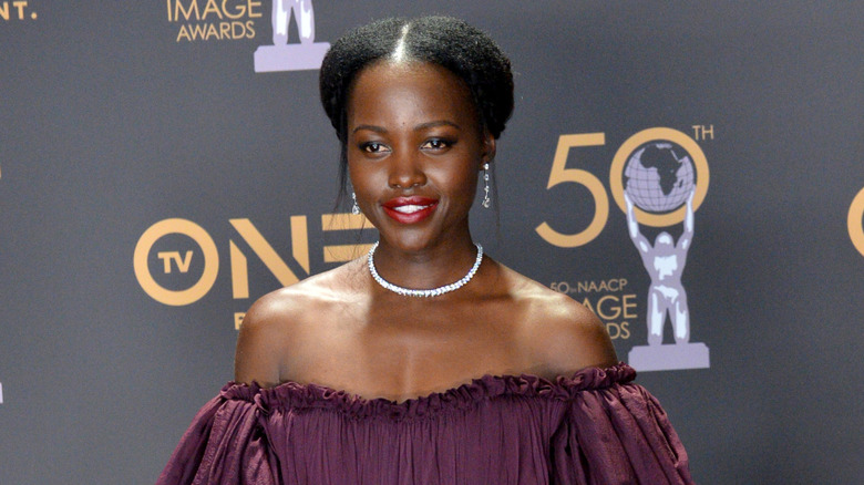 Lupita Nyong'o posing on a red carpet