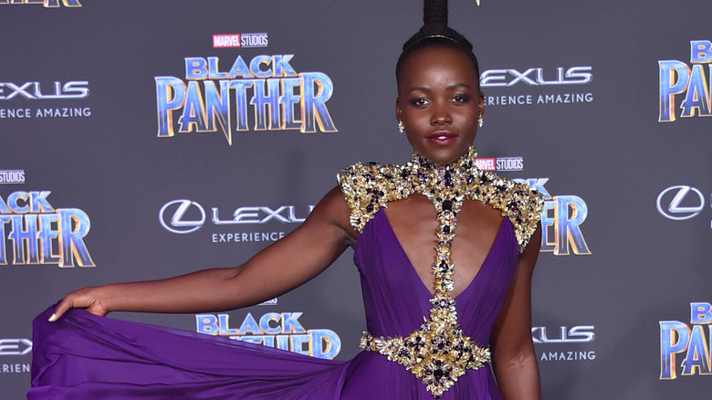 Lupita Nyong'o poses on a red carpet