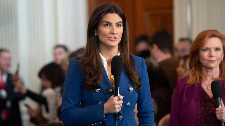 Kaitlan Collins talking into a microphone at the White House.
