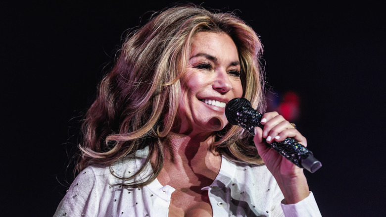 Shania Twain singing into microphone