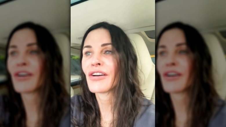 Courteney Cox sitting in her car