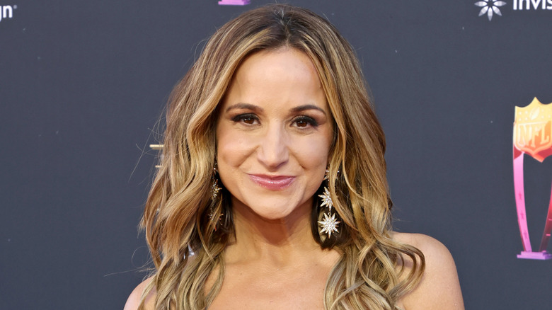 Dianna Russini wearing starburst-shaped dangle earrings.