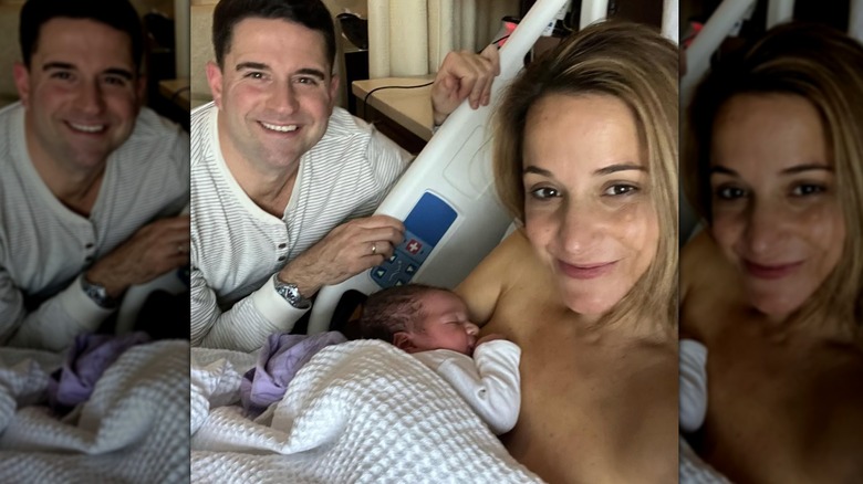 Dianna Russini holding her newborn baby in a hospital bed as Kevin Goldschmidt crouches down beside her.