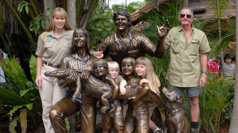 Terri Irwin posing with statue of Steve Irwin