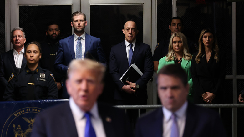 Karoline Leavitt lurking behind Donald Trump as he speaks