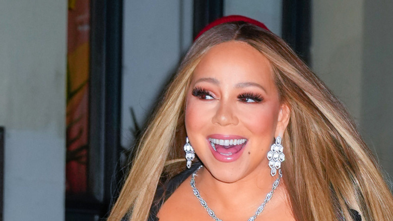 Mariah Carey smiling and walking