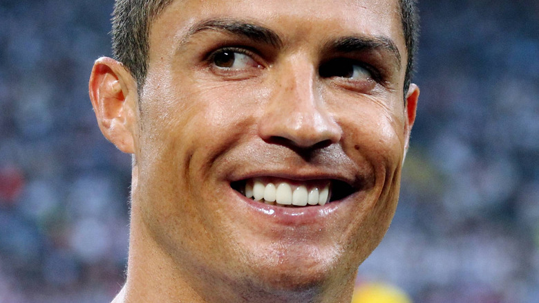 Cristiano Ronaldo smiles on a soccer field