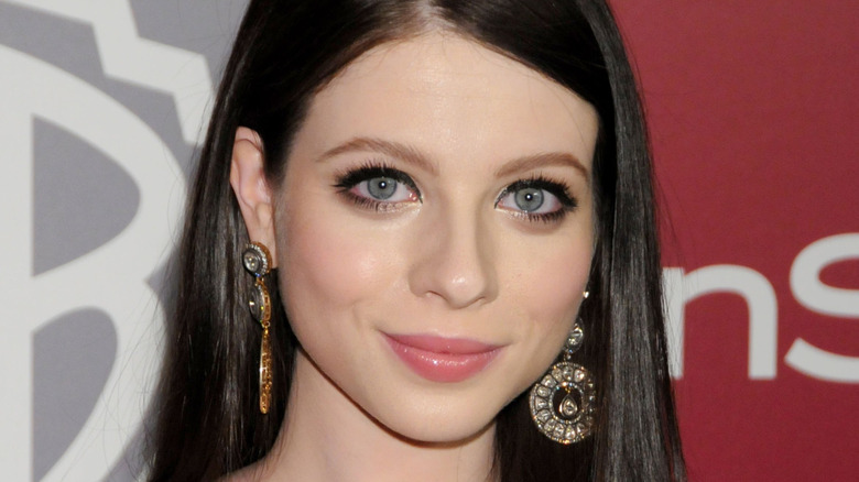 Michelle Trachtenberg wearing big earrings at an event