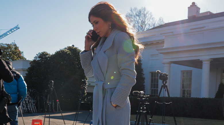 Kristi Noem walking outside the White House.