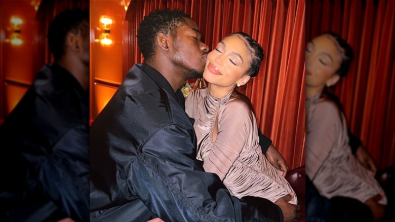 Damson Idris kissing Lori Harvey on the cheek