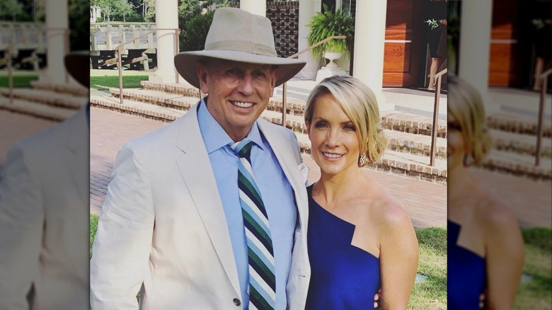 Dana Perino and Peter McMahon dressed up in formal attire in front of a building with white columns.