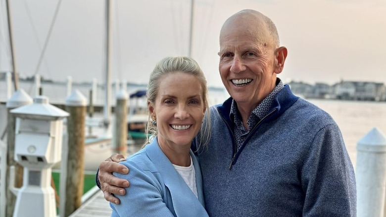 Dana Perino and Peter McMahon pose on a boat dock.