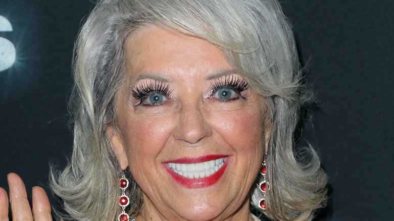 Paula Deen smiles with wide eyes