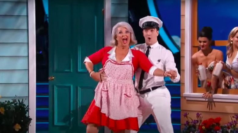 Paula Deen dressed in red dancing