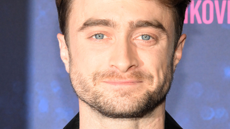 Daniel Radcliffe smiling rainbow backdrop