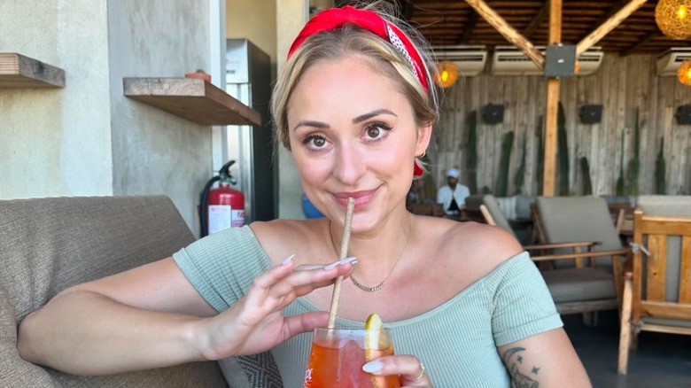 Renee Poche sips a drink