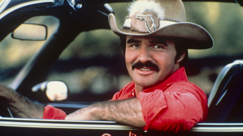 Actor Burt Reynolds driving a car and wearing a Florida cowboy hat in the '70s