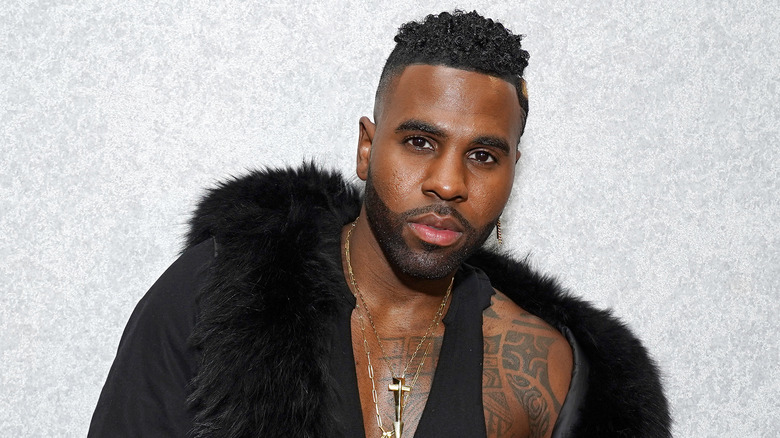 Jason Derulo posing against a white wall