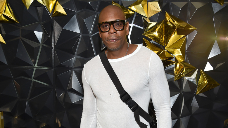 Dave Chappelle posing with big glasses on