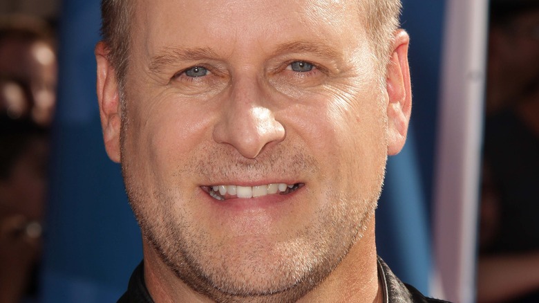 Dave Coulier wears a leather jacket and v-neck tee