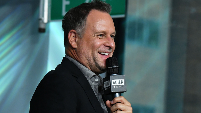 Dave Coulier speaking into a microphone