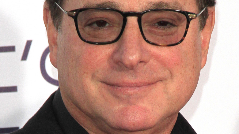 Bob Saget smiling on the red carpet