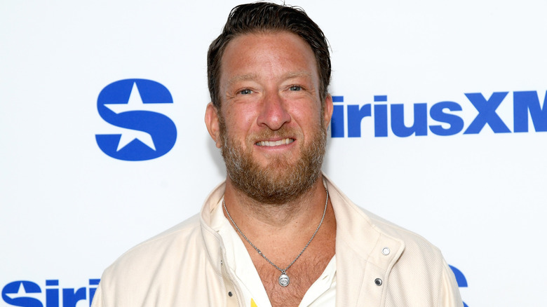 Dave Portnoy posing in an unbuttoned shirt
