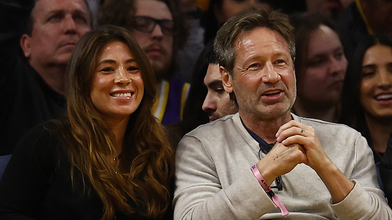 David Duchovny and Monique Pendleberry at a basketball game.