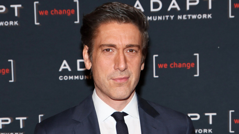 David Muir poses in a suit in 2022