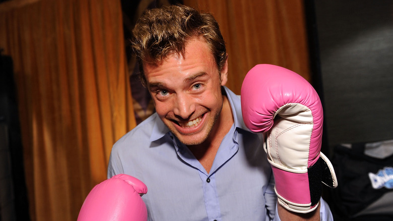 Billy Miller smiling pink boxing gloves