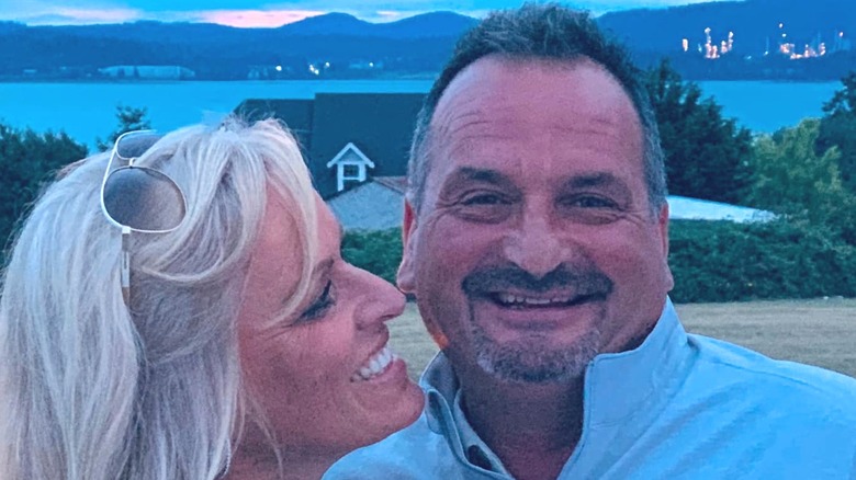Nick Mavar smiling beside his wife